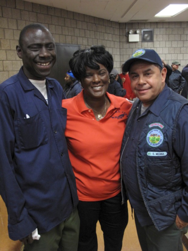 City Parks workers Mamadou N'doye (left) and vffff Medina with Local 1505 President Dilcy Benn at a union meeting.