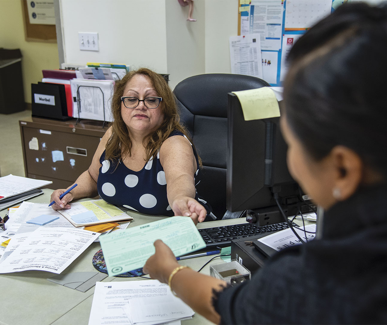 DC 37 Council Rep Norita De Taza, right, signs up a Local 2054 member. Photo: Clarence Elie-Rivera.