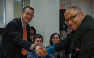 DC 37 Executive Director Henry Garrido, right, and Labor Commissioner Robert W. Linn shake hands after the union and city agreed on the contract extension. Photo: Mike Lee