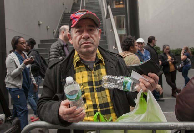 Custodial Assistant Raymond Luciano holds bottles, which he plans to recycle to supplement his frozen pay. He earns about $150 every two weeks by recycling.